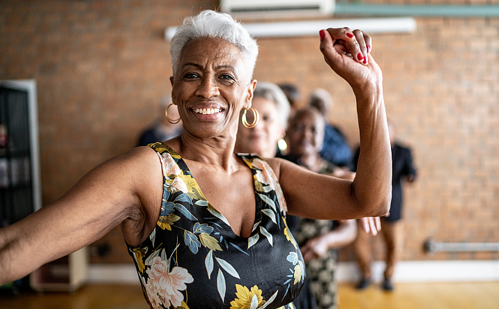 older adult woman working out in exercise class